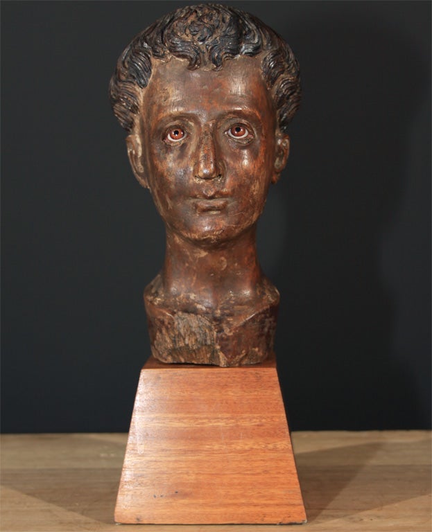 Philippine carved wood head St. Antonio de Padua. The finely carved wood head with tonsured hair and inset painted glass eyes.