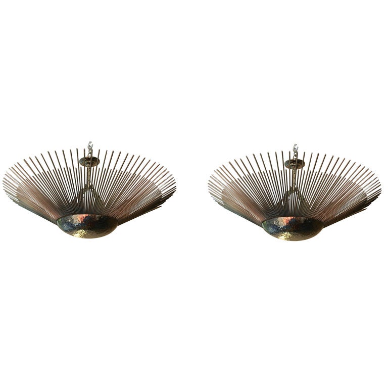 A pair of large circa 1940s French nickel-plated light fixtures with hammered body with rays projecting from the center and interior lights. Sold individually.

Measurements:
Height (minimum drop) 11.5