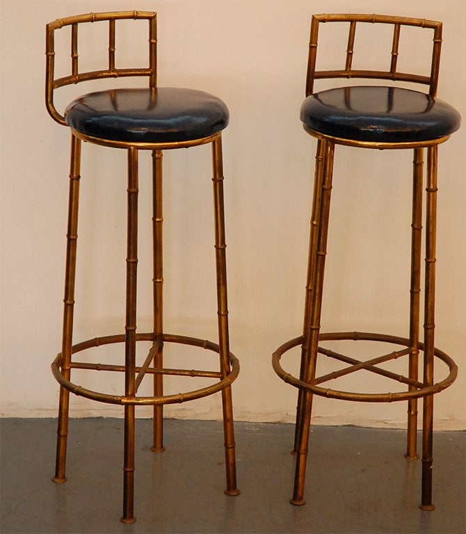 Italian brass faux bamboo barstools.  Overall great condition with nice patina.  Reupholstered in navy patent leather.