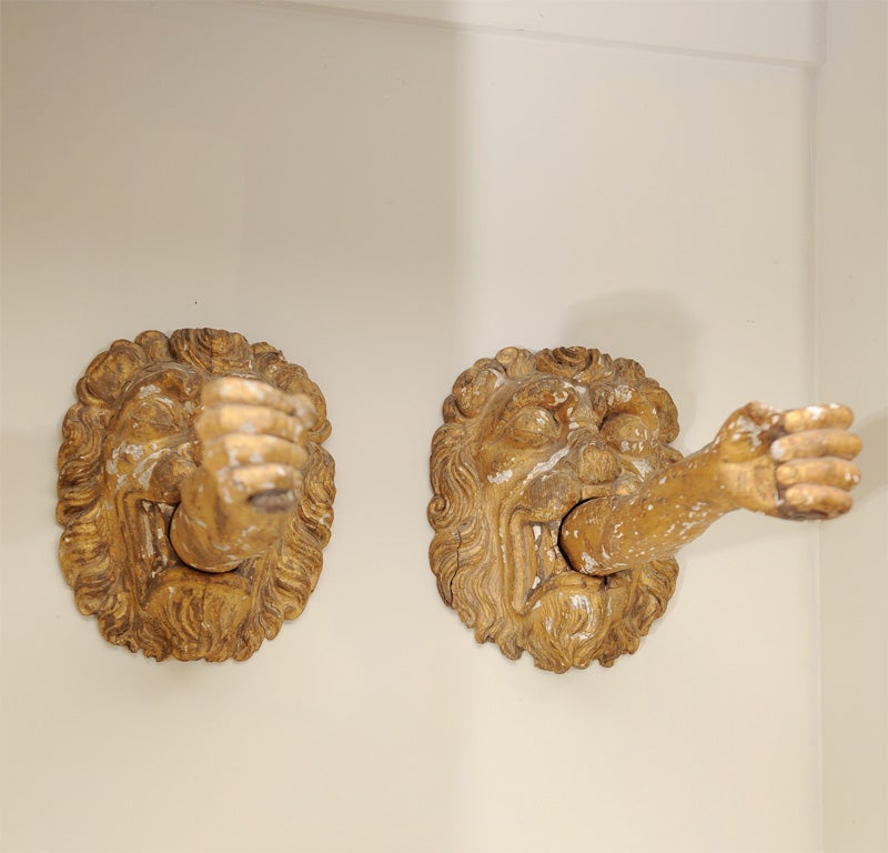 Pair of Venetian carved wood gilt lions mask with inserted arms sconces.