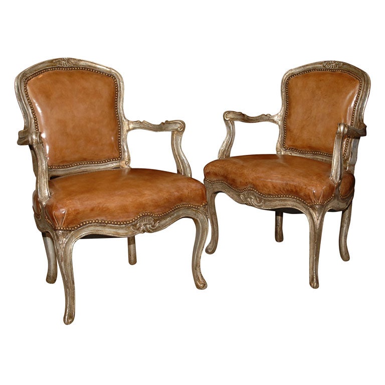 A pair of Venetian silver gilt armchairs