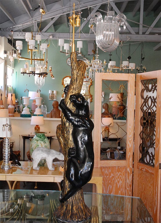 Monumental pair of panther table lamps. Panthers are painted in black, climbing a gilded tree.