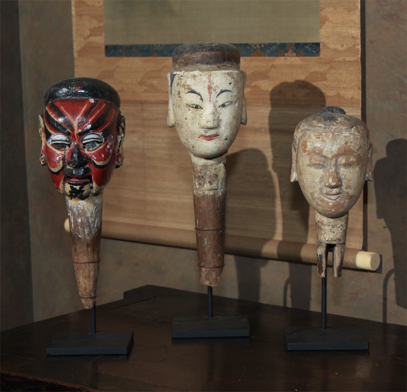 Chinese carved wood puppet heads with gesso finish and red and black painted facial features. Elaborate makeup like this derived from Classical Chinese Operas, particularly for Provincial performances in places that could not afford to pay for a