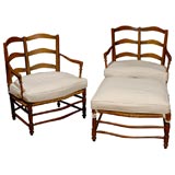 Pair of French lounging chairs with ottoman, 19th Century