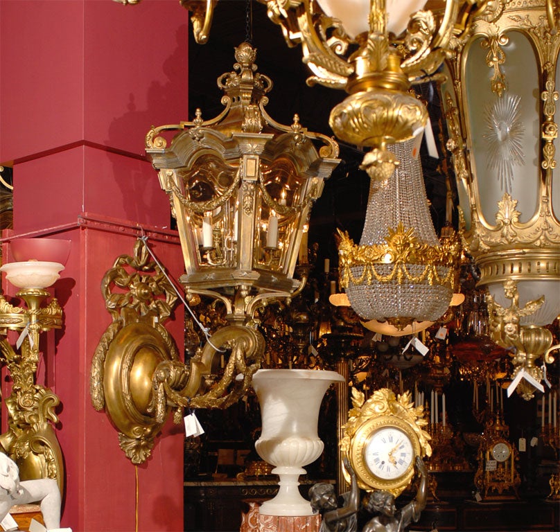 Superb pair of gilt bronze brackets and lanterns with beveled glass. Four lights each.