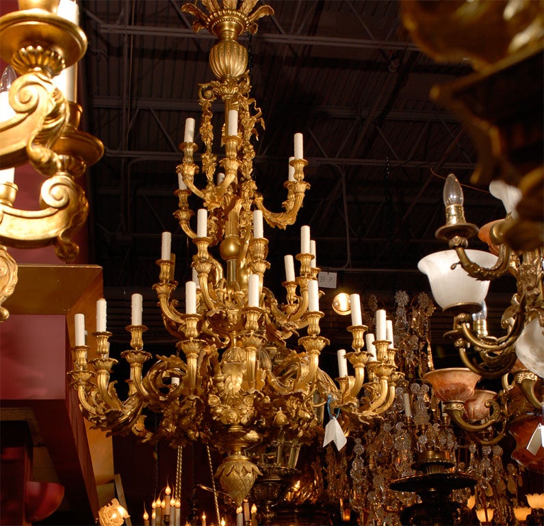 An imposing gilt bronze chandelier depicting mermaids, a true work of art. 33 lights