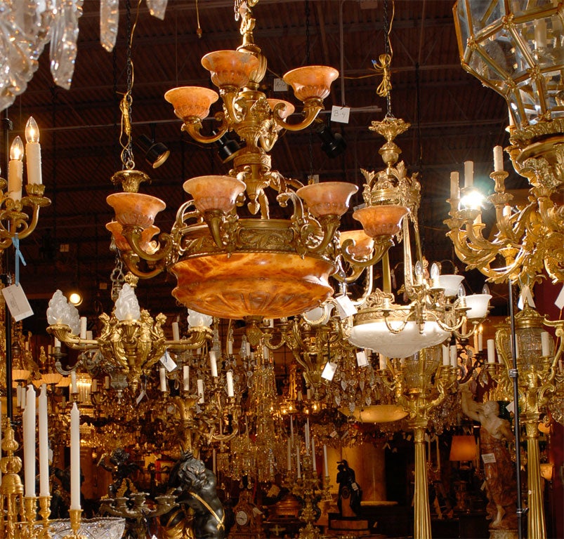 Magnificent twelve-arm two-tiered gilt bronze chandelier with alabaster dome and shades, dome has four inside lights.