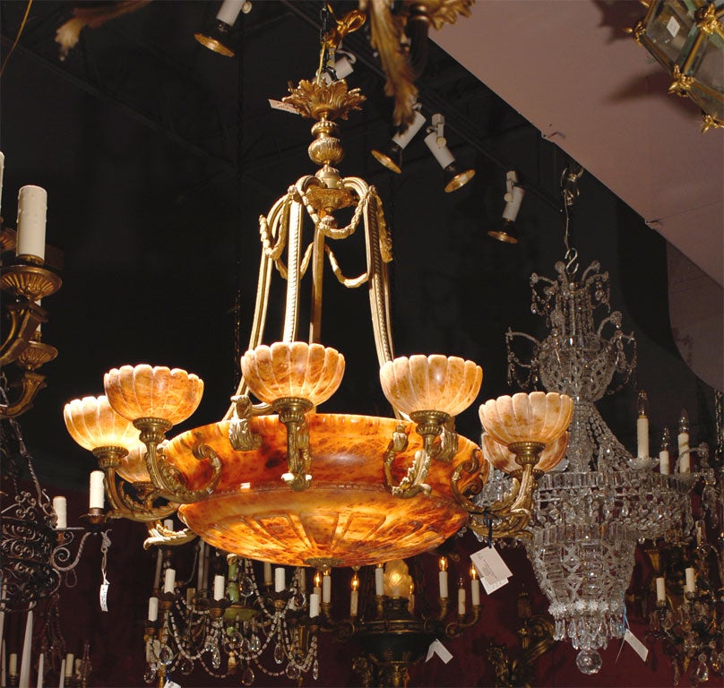 Magnificent ten-arm gilt bronze chandelier with alabaster shades and dome. Six internal lights.