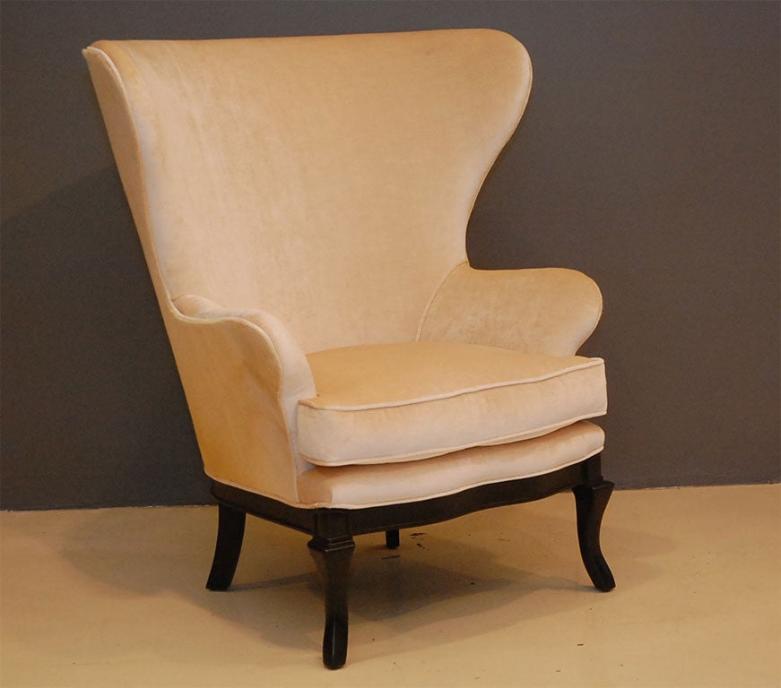 Pair of Modern Wing-back Chairs with smooth front saber legs and a dramaticly curved back. Shown in new antique ivory velvet and white cowhide backs. Also, available to order COM.  Inquire within.
