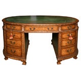A very good oval or elipse shaped English desk in burr walnut.