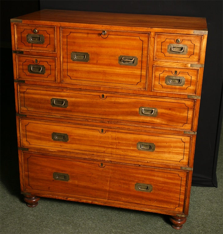 A very good 19th century Colonial 2 part chest of drawers.<br />
The chest is made from satin teak with camphorwood lined drawers. the center section pulls out to reveal a leather lined writing surface, while the drawer above conceals a pull out