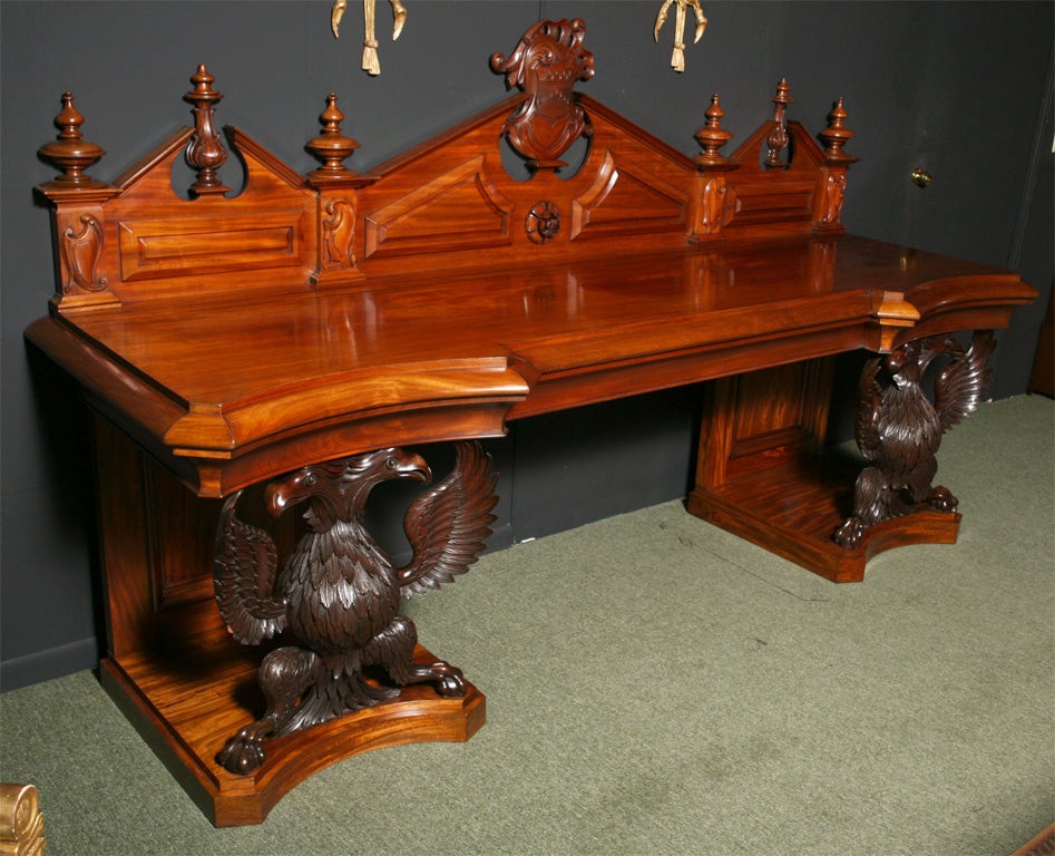 A very impressive Irish serving table in mahogany believed to be by Stahan of Dublin. The table has a carved and paneled back with an Irish Harp shape to each end and a central coat of arms, this coat of arms represents the Lloyd family of County