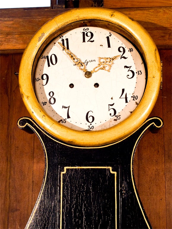 Whimsical gilt and black painted Dutch corner cabinet with clock face.