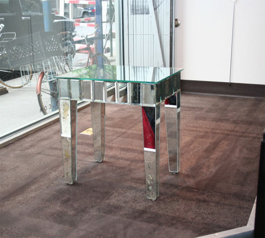 Table has antique mirrored panels, all hand beveled. Used in a home decorated by Billy Baldwin.
