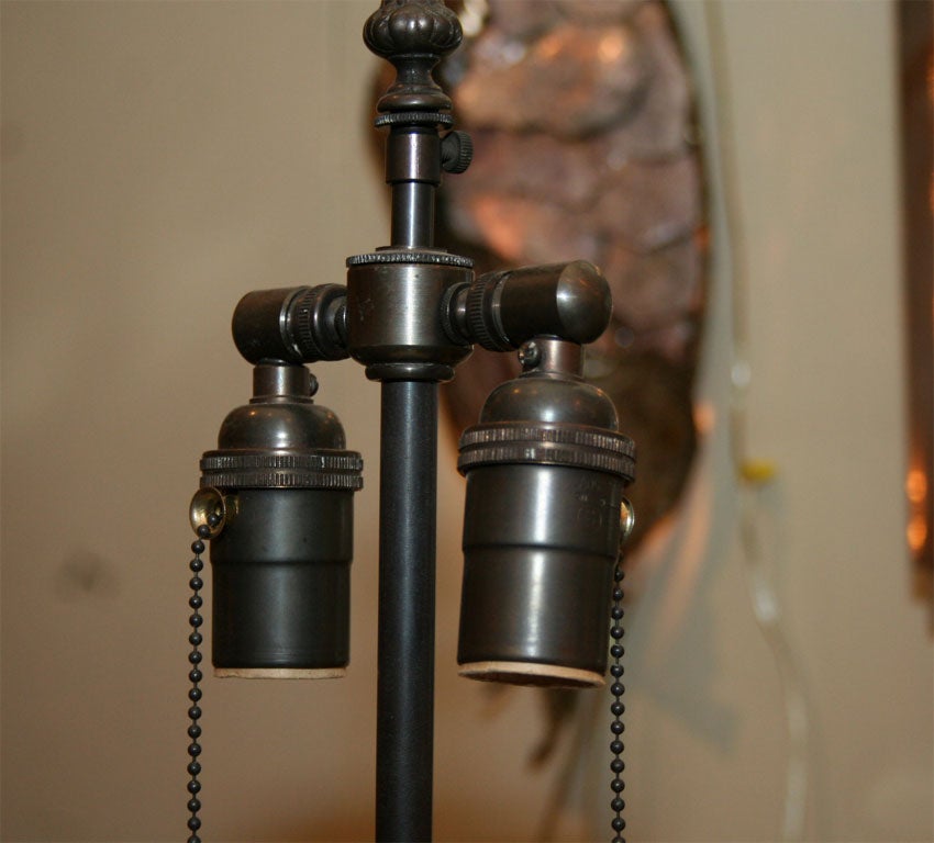 Pair of ceramic face lamps on painted metal bases