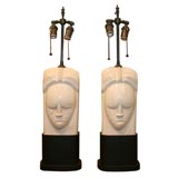 Pair of ceramic face lamps on painted metal bases