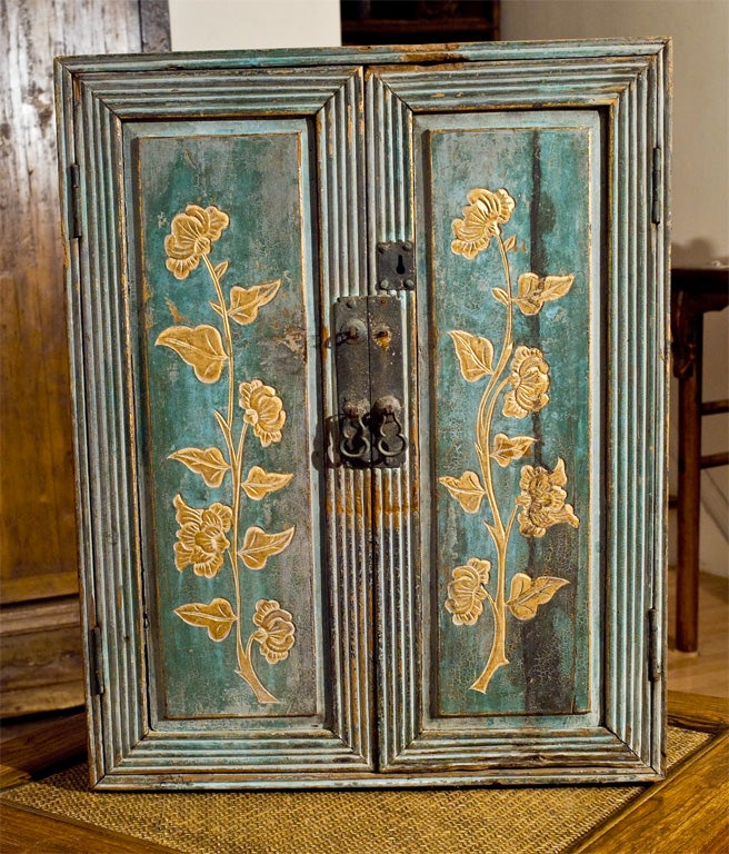 Small, rustic painted cabinet.