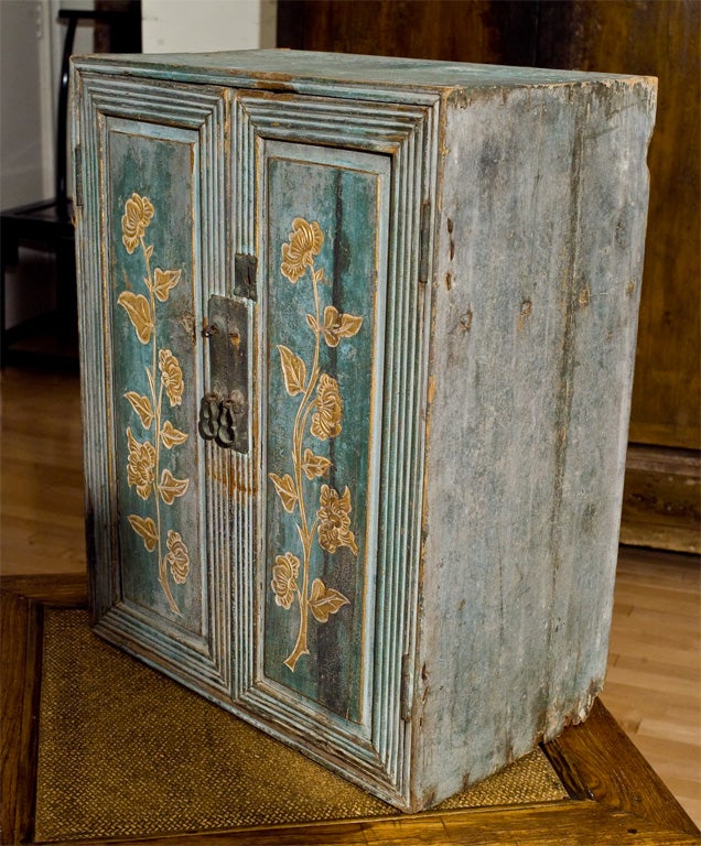 Chinese Small painted cabinet with gilt floral painting in front