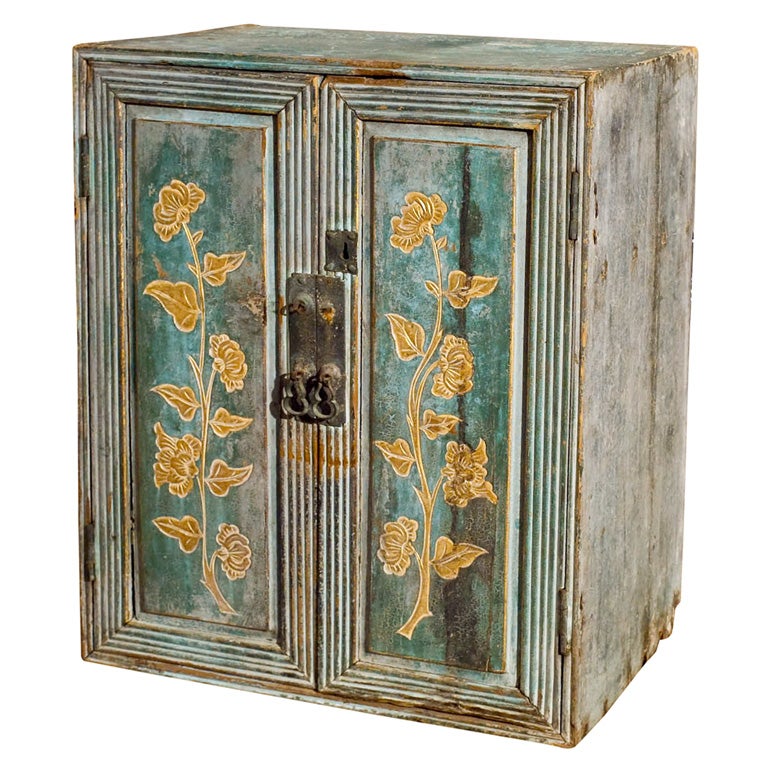 Small painted cabinet with gilt floral painting in front