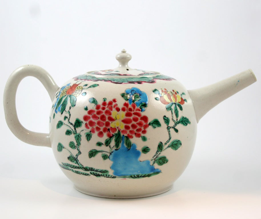 A fine English saltglazed stoneware teapot decorated with Oriental flowers