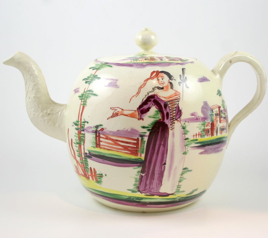 A fine English creamware teapot painted in the style of David Rhoades with a woman and house
