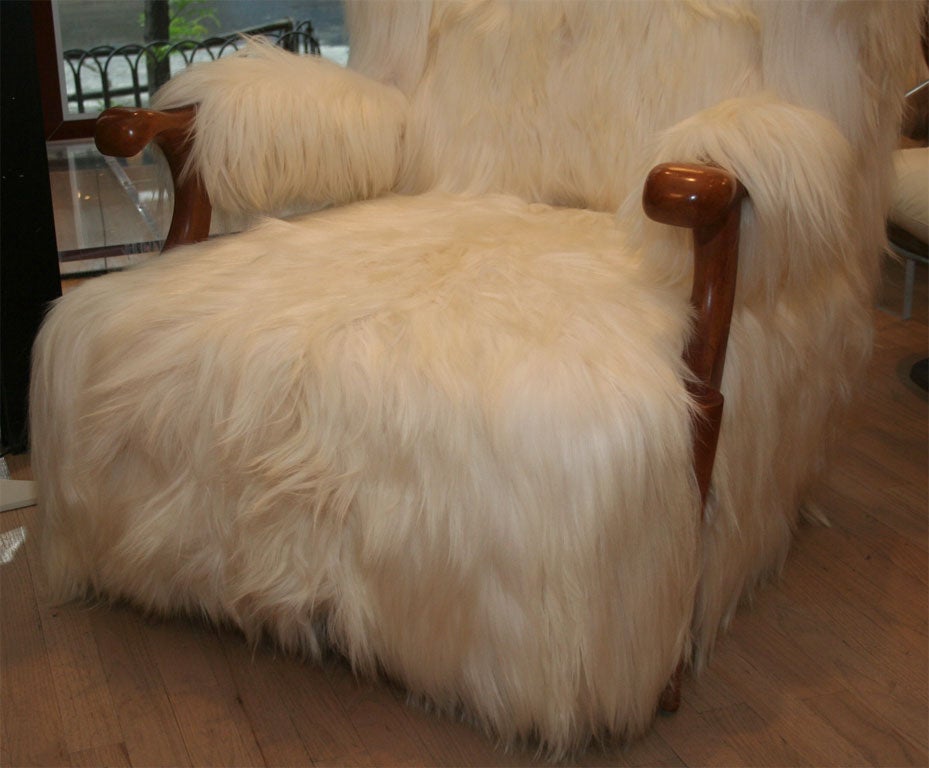 Beautiful pair of wing chairs by Rene Drouet, of note is the graceful curve of the Sycamore legs and the Mongolian long haired lamb upholstery.