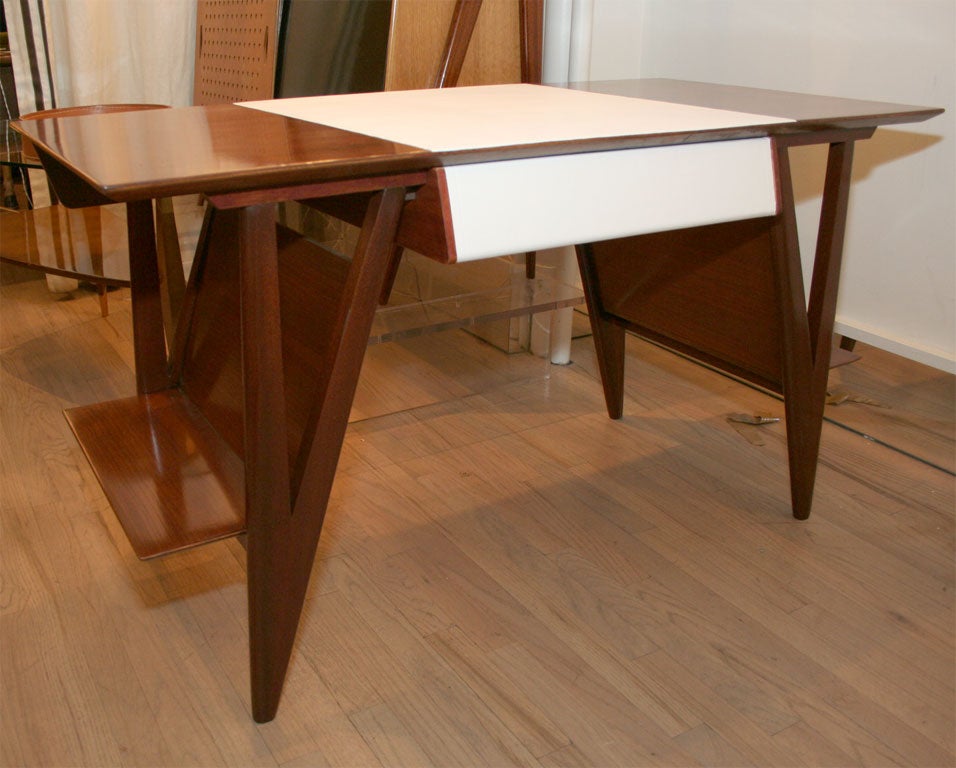 Fine mahogany desk by Louis Paolozzi, Very nice geometry and a leather covered writing surface and drawer.