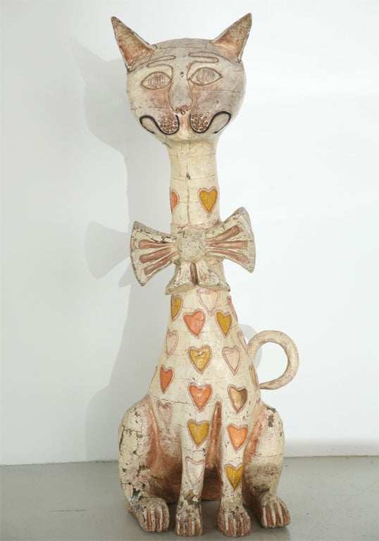Huge papier mache sculpture of a cat with a bow. Creamy buffy distressed paint with a 