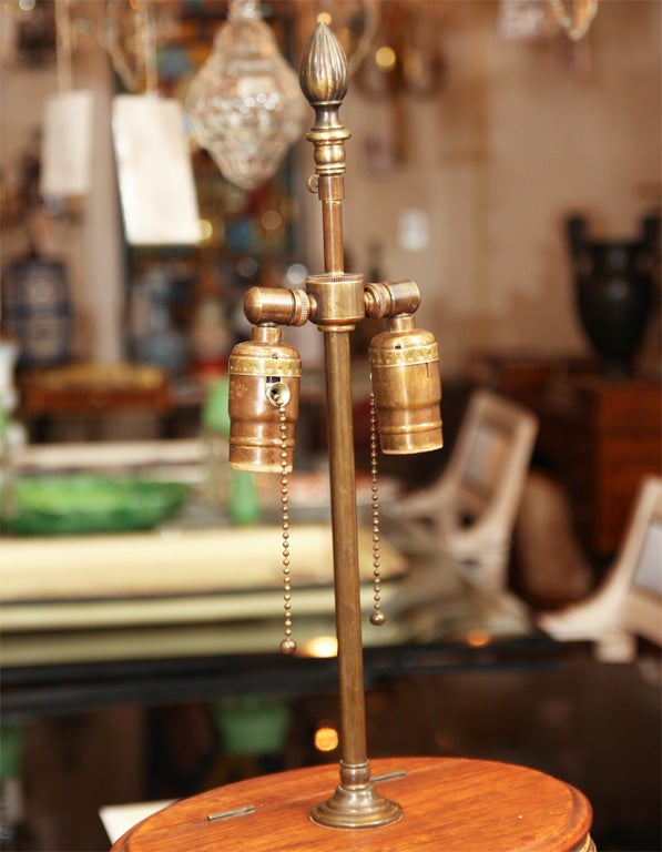 A wicker bound oak cask with silver ring form handles, flip top, and repousse fish motif plaque. Now mounted as a lamp.