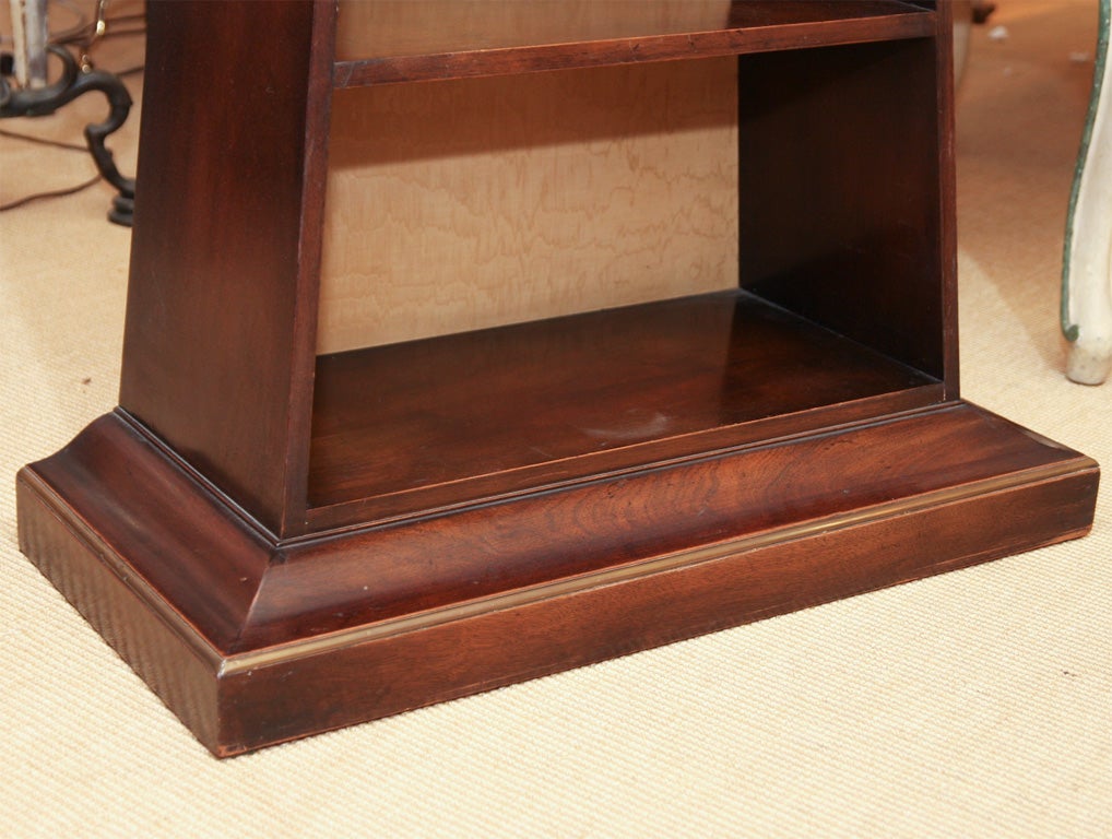 English Regency style mahogany display shelf with brass trim, the shelves backed with pale yellow water silk.