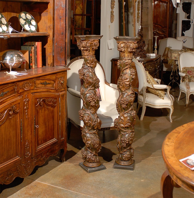 A pair of French Baroque style hand carved, painted and parcel-gilt Solomonic columns from the 18th century, with vine motifs and Ionic capitals. Born in France during the Age of Enlightenment, each of this pair of Solomonic barley twist columns