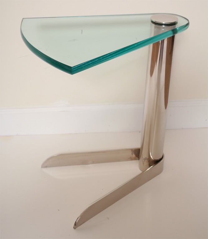 Sculptural side table with a slice of pie shaped glass top. Nickel silvered column pedestal with matching disk cap on top of glass. V shaped steel band as base mimicking the pie shape. Great 3/4 inch thick glass.