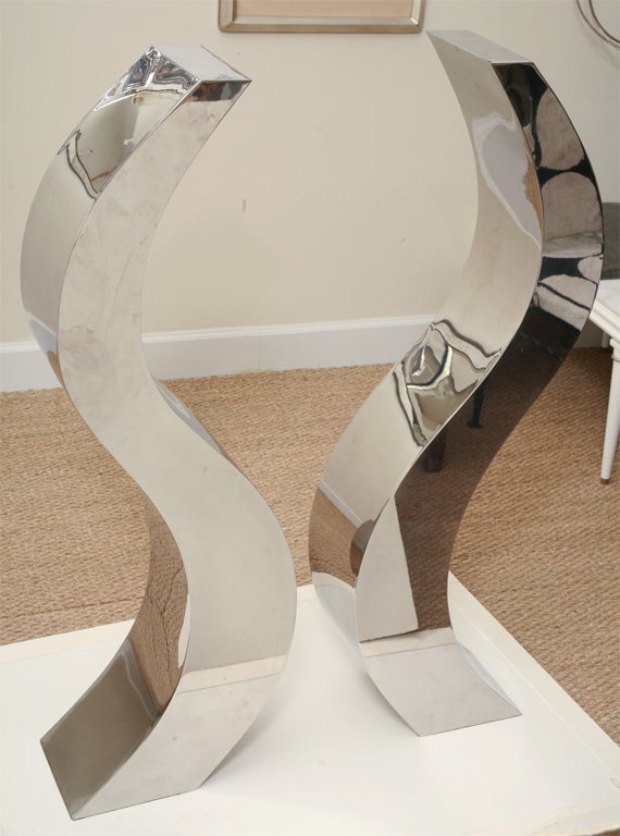 Two wonderful dramatic sculptures made of polished stainless steal and signed by the artist . They are one of a kind and were custom made for an entrance way. They are made for indoor and outdoor usage. The sculptures are not only signed by the