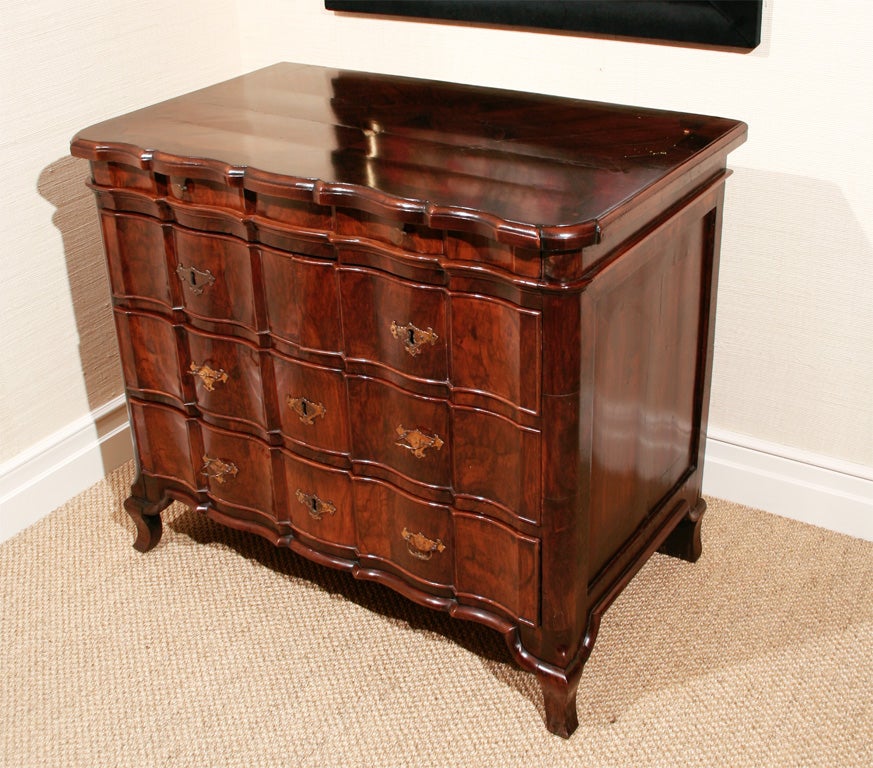 A Dutch Baroque walnut chest of drawers with cusped and shaped top over undulating drawers on raised bracket feet.