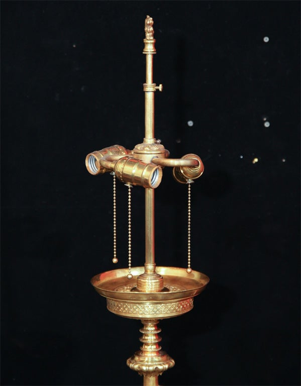Gilt bronze decorated floor lamp with paw feet.