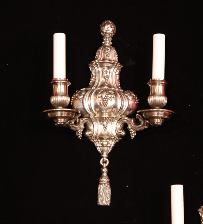 Silver on copper repousse sconces decorated with grapes and leaves by E. F. Caldwell.