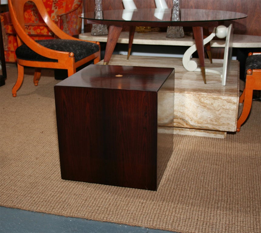A set of six interlocking rosewood nesting tables with chromed steel legs expertly engineered to nest into a discreet cube end table with a blonde birch finger button on the top table. By Poul Norreklit for GP Farum. Denmark, circa 1960.