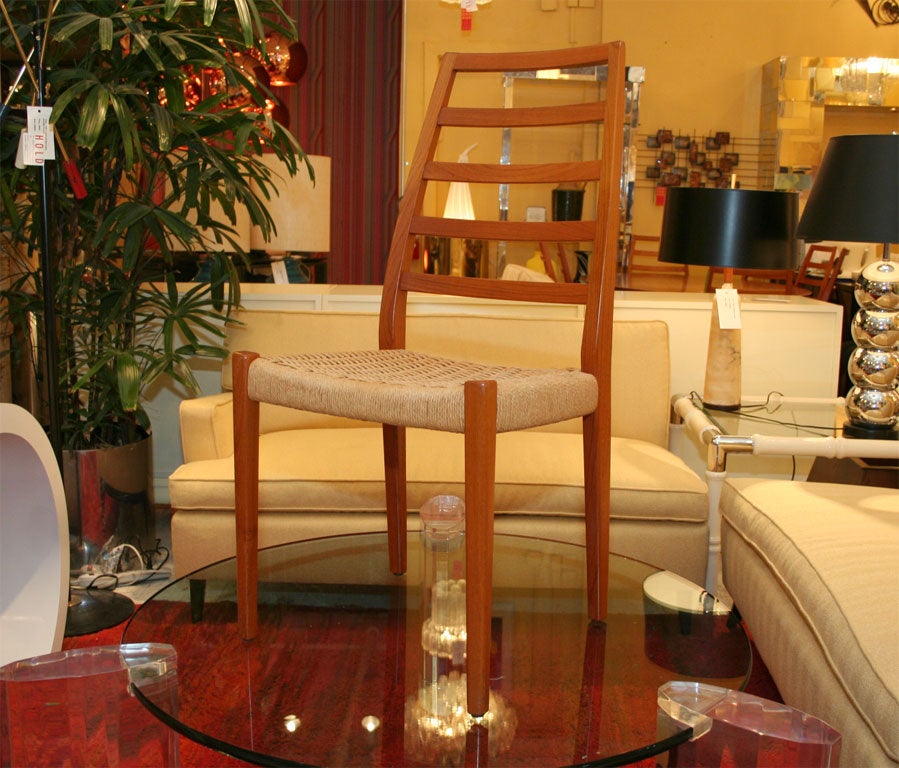 Set of eight teak ladder back chairs with woven rope seats. <br />
Located at ABC Home 212-473-3000 x519