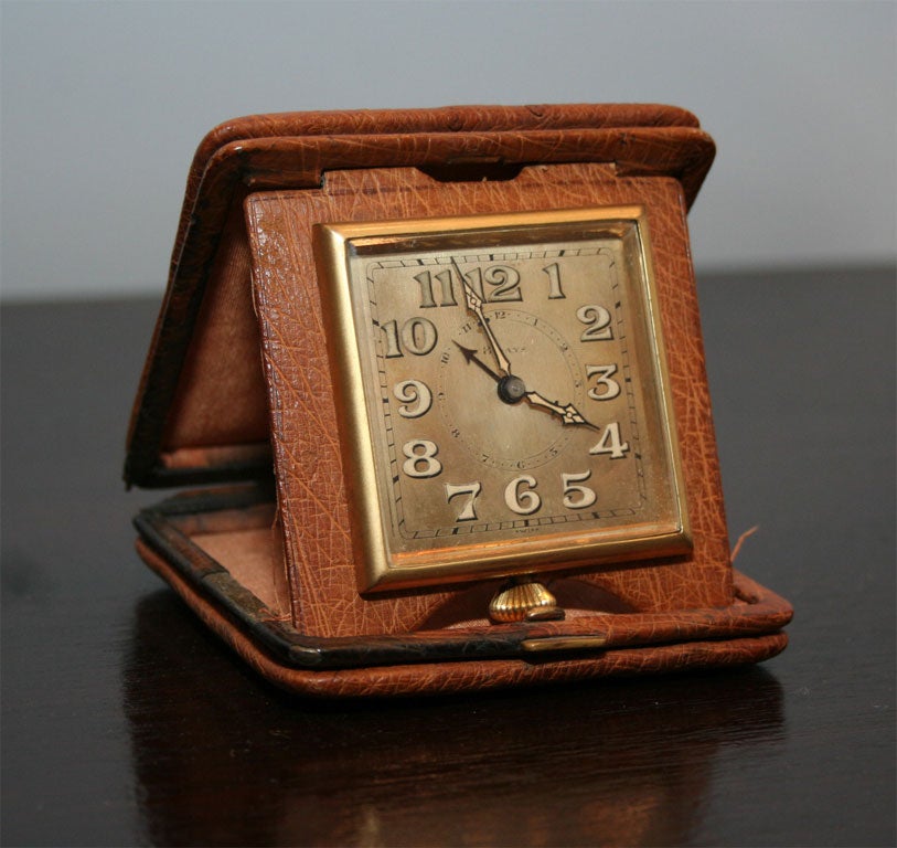 Leather travel clock with brass hardware. 
(Note: the green clock in the images is no longer available)