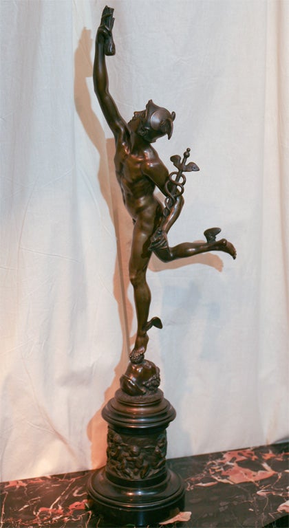 Bronze statue of Mercury on a bronze and marble base. The base is decorated with relief Putti playing musical instruments