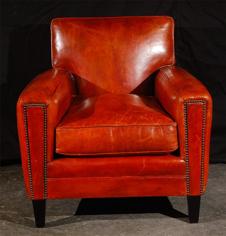 1950's flair for this armchair by Jean de Merry workshop.<br />
Walnut Feet with Brown Satin finish, Hand-tied Coil Spring Seat<br />
French Spring with Feather Down Envelope seat cushion, Antiqued Nail Heads.<br />
JDM Hand-dyed Leather and