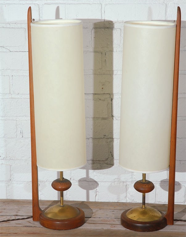 A Unique Pair of Modeline Cylinder Table Lamps.  Teak & Brass base with Teak Arm Support and Original Shade.  Lamp turns on by pressing down on cork ball on base.  Very Unique in design.