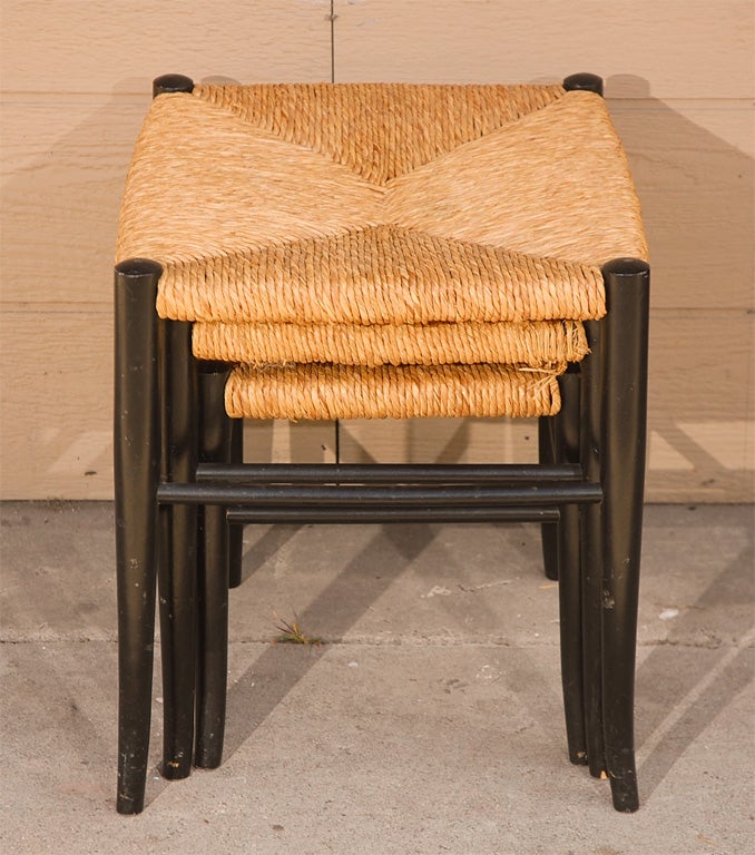 A set of 3 Rush Nesting stools/tables with black wood frame.  Nice tapered, flared legs give these stools an elegant feel.