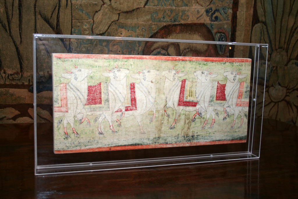 An 18th century pichwai on painted cloth from a temple wall in Rajasthan depicting smiling cows covered in robes being tended by munificent monks.  These cows are a free and honored animal in their country.  Finely drawn depictions and lovely muted