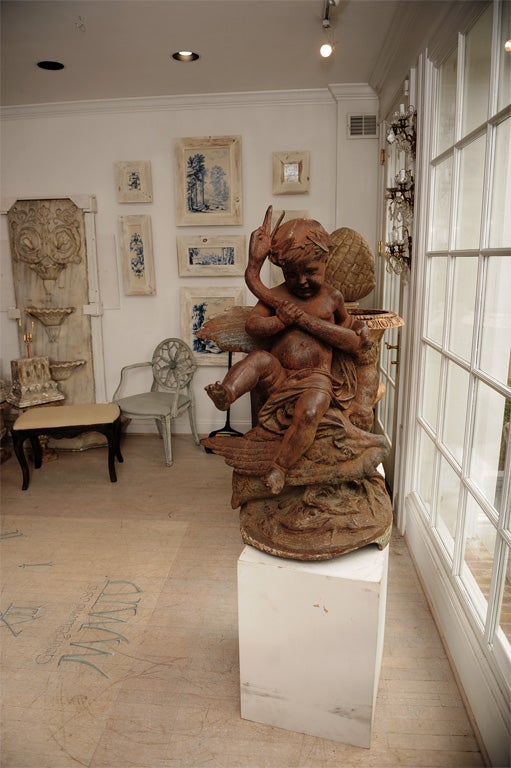 Cast Iron Fountain with a Boy Holding a Swan.  <br />
Working Condition.  This fountain was featured in a <br />
Garden Catalogue that was published around 1875 by a famous foundry company outside of Paris.  The foundry A. Durenne of<br