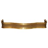 Antique English brass serpentine fender.