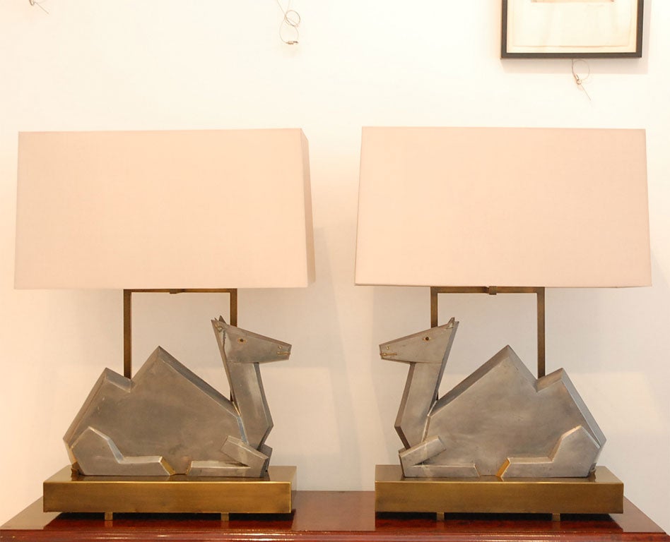 We took a pair of large 1970's era pewter and brass camel sculptures and placed them on new production lamp bases of patinated bronze with new silk shades.<br />
<br />
Very bold and interesting pair of lamps with a beautiful sheen.