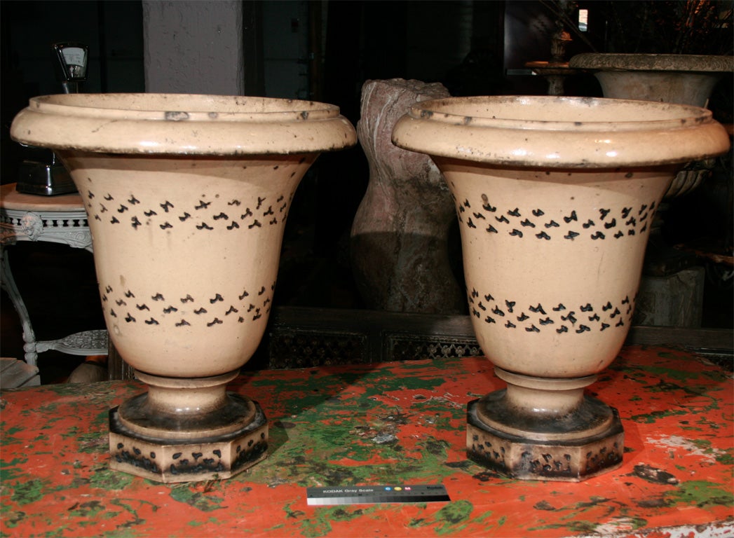 Pair of late 19th century English glazed stoneware campana form urns with blue incised decoration.