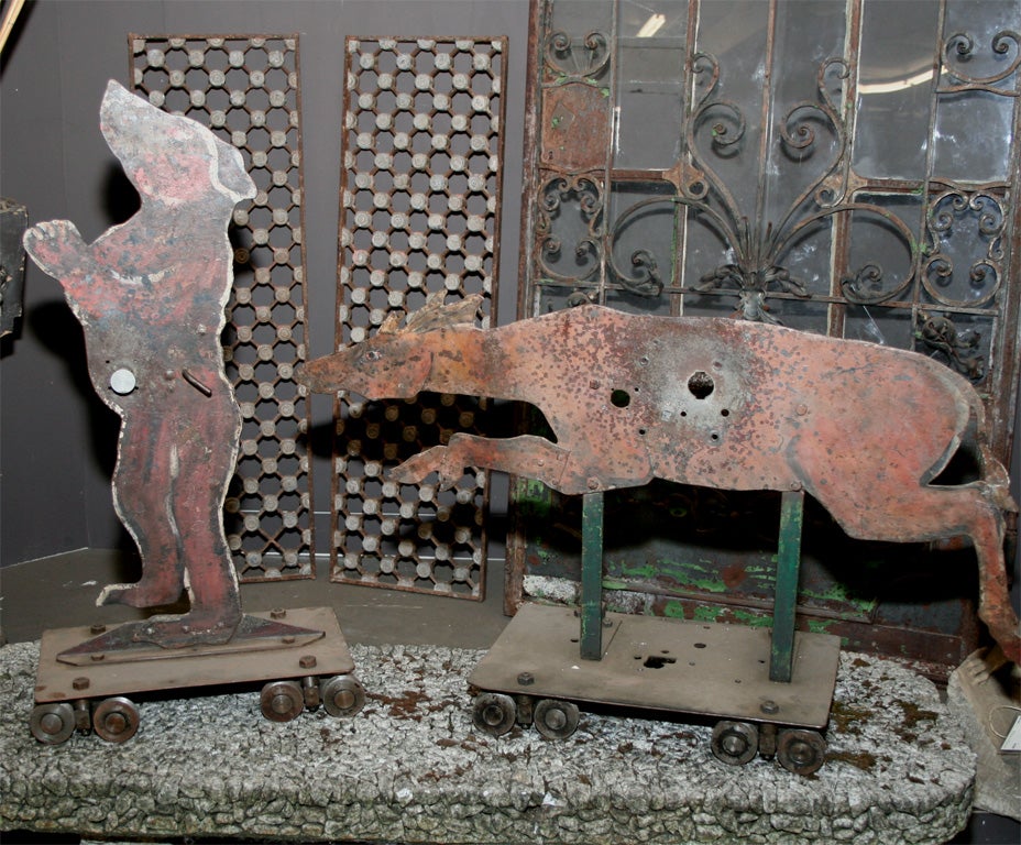Wonderful pair of painted metal French shooting gallery targets on original wheeled carriages.   The horse is 28