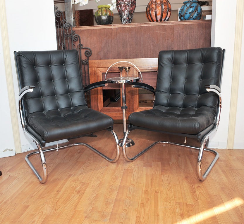 A fantastic pair of chrome Czech chairs, circa 1930s, newly upholstered in black leather (matte finish) with multiple button detailing, which creates a wonderfully modern look. Also works great with Mid-Century design. 22.5